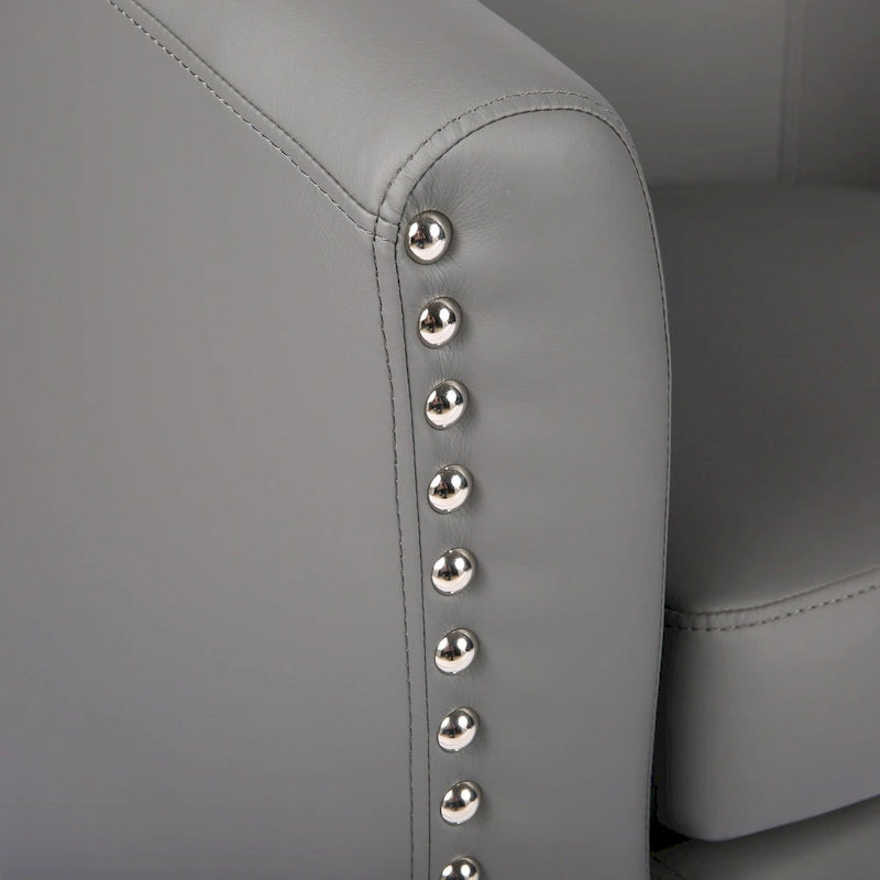 Sillón individual tipo barril de piel sintética con detalles de tachuelas