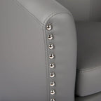 Sillón individual tipo barril de piel sintética con detalles de tachuelas